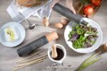 KOPOS® Greek Extra Virgin Olive Oil being drizzled over a fresh salad