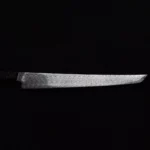 Side profile of the Skelmis Sujihiki Sakimaru, showcasing its balanced design and sleek blade.