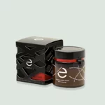 Jar of Greek Premium Raw Honey, Arbutus Wild Strawberry Honey, from Eulogia of Sparta with a rich golden color and unique label design.