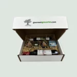carton gift box with gourmet groceries logo including wine,honey,evoo and herbal tea and cooking herbs from ikaria island