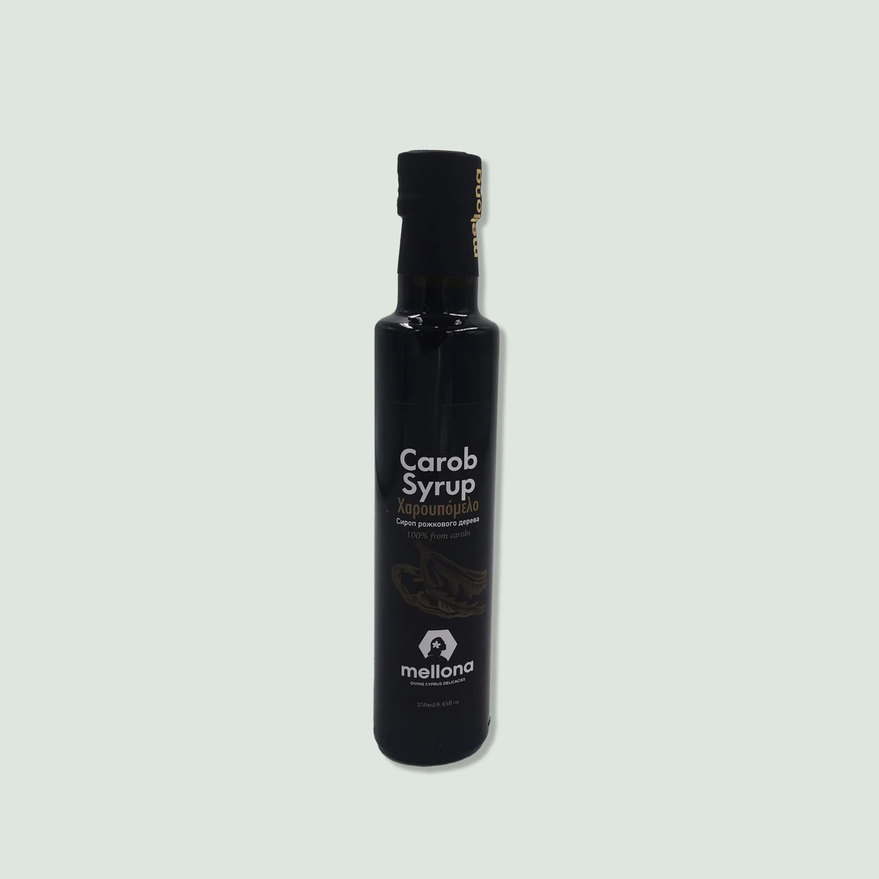 Carob Syrup A black bottle of Mellona Carob Syrup with a black cap and label, displaying the product name in English and Greek, and a small logo at the bottom.