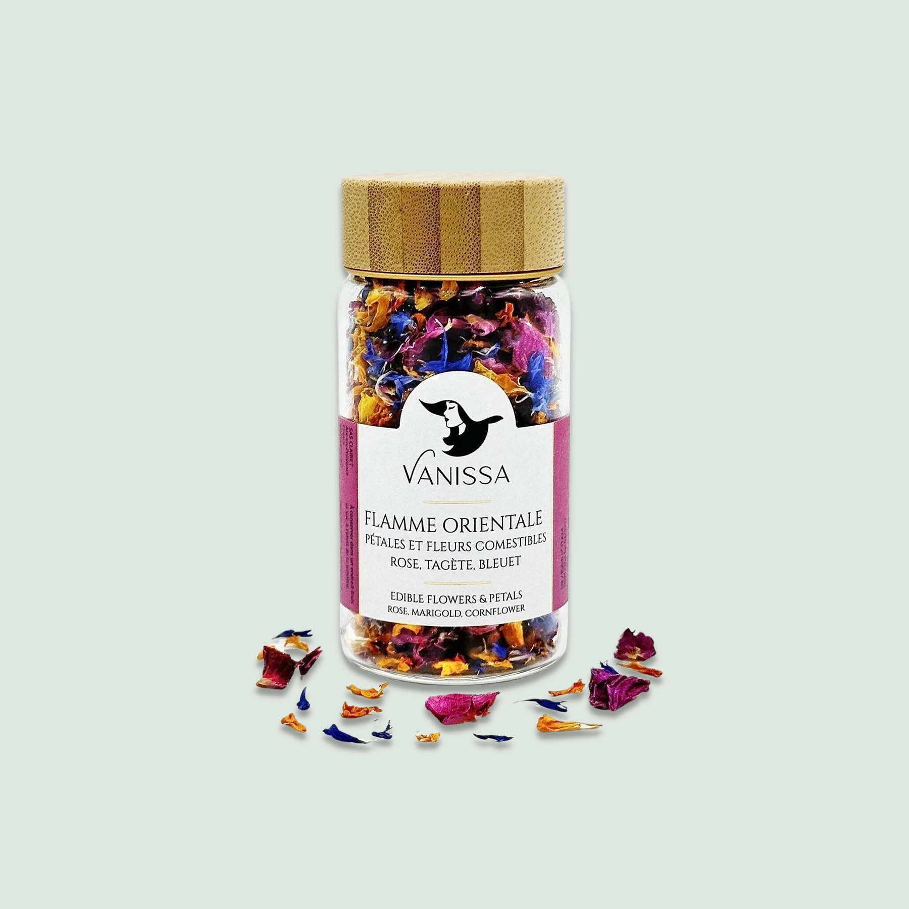 Flamme Orientale Edible Flowers Bottle - Front View A front view of the Flamme Orientale edible flowers bottle, showcasing vibrant rose, tagetes, and blueberry petals inside a glass jar