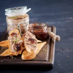 A gourmet platter featuring Royal Pate Foie Gras served with slices of fresh baguette