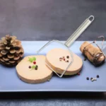 Wire foie gras cutter making clean slices on a block of foie gras