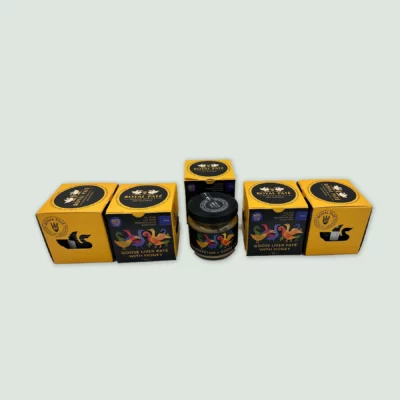 Five elegant jars of Royal Goose Liver Pate with Hungarian honey, lined up on a wooden surface, ideal for gifting or gourmet gatherings.
