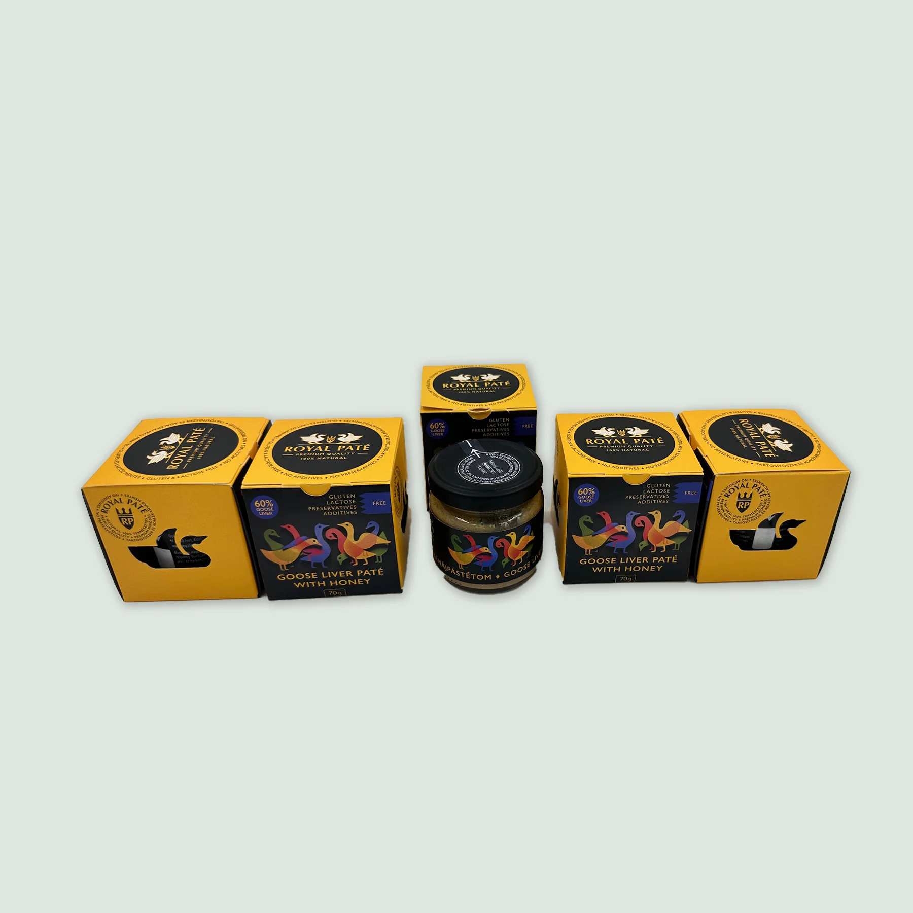 Royal Goose Liver Pate – Set of 5 Jars Five elegant jars of Royal Goose Liver Pate with Hungarian honey, lined up on a wooden surface, ideal for gifting or gourmet gatherings.