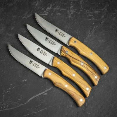 Handcrafted Claude Dozorme steak knives with satin-finish stainless steel blades.