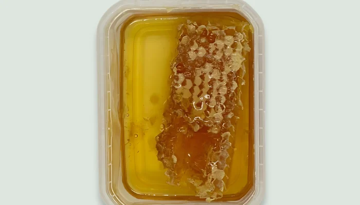 Honey Comb Beekeeper Family The Beekeeper Family Papadopoulos Honey Comb emphasizing the purity and natural origin of the product.