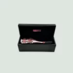 The luxurious packaging of Armand De Brignac Rosé Champagne, designed by renowned fashion house André Courrèges.