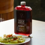 Luxury red glass bottle of Verde Esmeralda Red Diamond EVOO