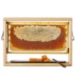 Fresh Paliouri honeycomb with natural golden honey sealed inside the wax cells.