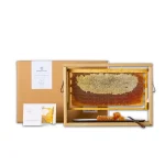 Papadopoulos Beekeeper Family raw honeycomb displayed in a premium wooden frame.