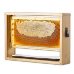 Close-up of natural raw Paliouri honeycomb in a wooden frame, showcasing its golden honey-filled cells.