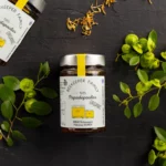 The elegant packaging of the organic Paliouri honey bottle, highlighting the colorful design and quality seal.