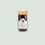 Close-up of Black Pepper Madagascar, featuring Voatsiperifery Wild Black Peppercorns in a 60g glass jar, showcasing their dark and aromatic peppercorns.