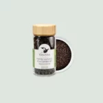 Hand-harvested Voatsiperifery Wild Black Pepper from Madagascar spilling from a glass jar