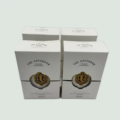 A front view of The Governor Premium Limited Edition Pack, featuring four bottles of high phenolic olive oil from Corfu, Greece.