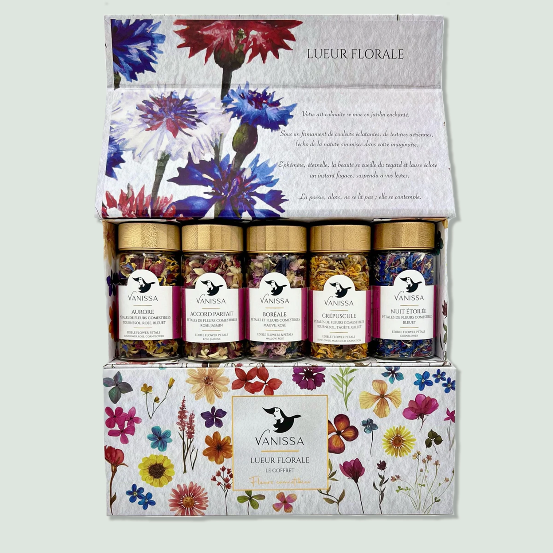 Edible Flowers Gift Box Set 5 Jars A box labeled "Lueur Florale" containing five jars of mixed herbs by Vanissa. The jars have golden lids and contain colorful blends of edible flowers and herbs. The box features a floral design with various flowers illustrated on it.