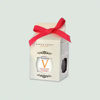 Vasilissa Wildforest Honey displayed alongside its beautifully designed box, emphasizing the premium quality and elegant presentation.