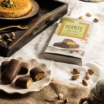 Laurence Kunefe dubai chocolate bar with crispy kataifi and pistachio cream, displayed on a plate.