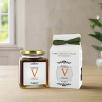 Vasilissa Organic Thyme Honey served with tea and a spoon on a wooden table